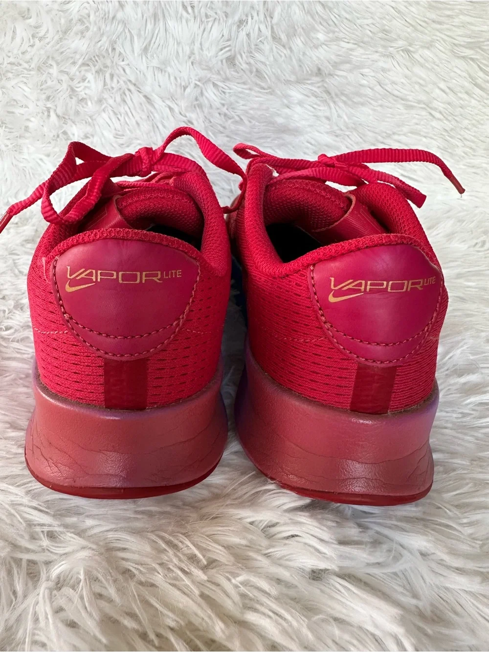 Nike Women's Bold Pink Athletic Court Shoes with Teal Purple Gradient Accent.